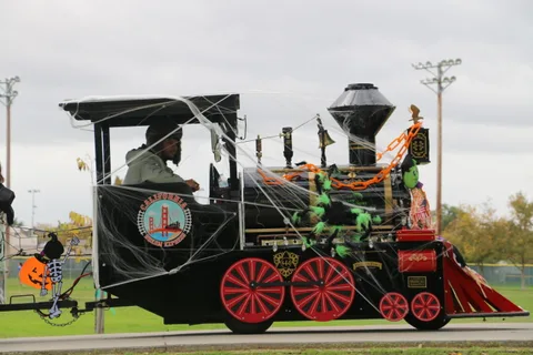 The cobweb-covered engine of the Halloween train, with its driver aboard.
