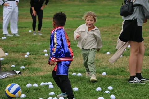 Two children run and play together during the festival games.