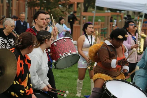 The full drum line performs together in colorful animal-print costumes.
