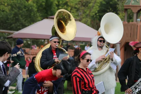 Sousaphone and tuba players perform in the marching band.