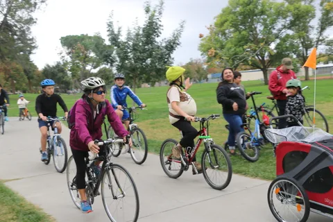 A group of riders converges at a path intersection.