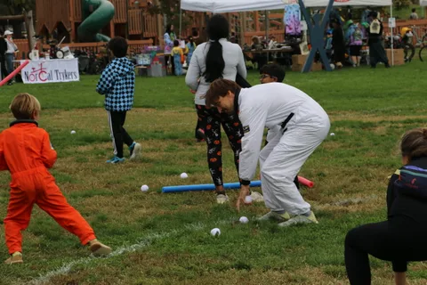 Two people move quickly across the festival field in this candid shot.