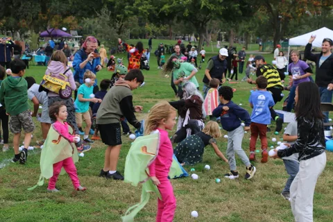 Kids in costumes fling balls into the air during the toss game.