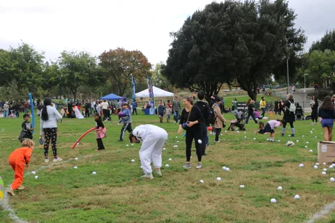 Players gather balls scattered across the festival lawn game area.