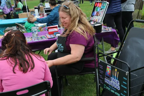 Children gather at the face painting tables during the festival.