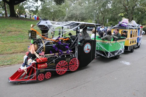 A skeleton-costumed figure sits inside a cobweb-decorated locomotive car.