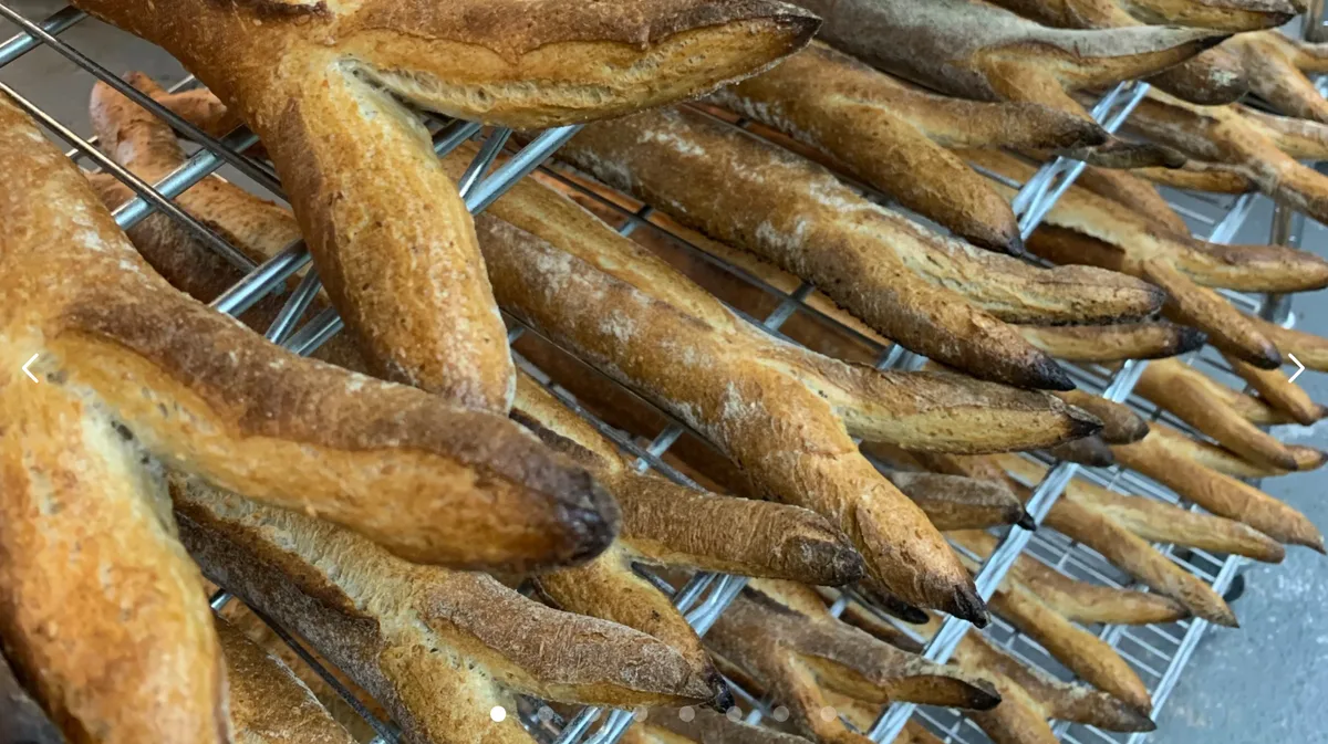 A row of skewered dried fish snacks is displayed at a food vendor.