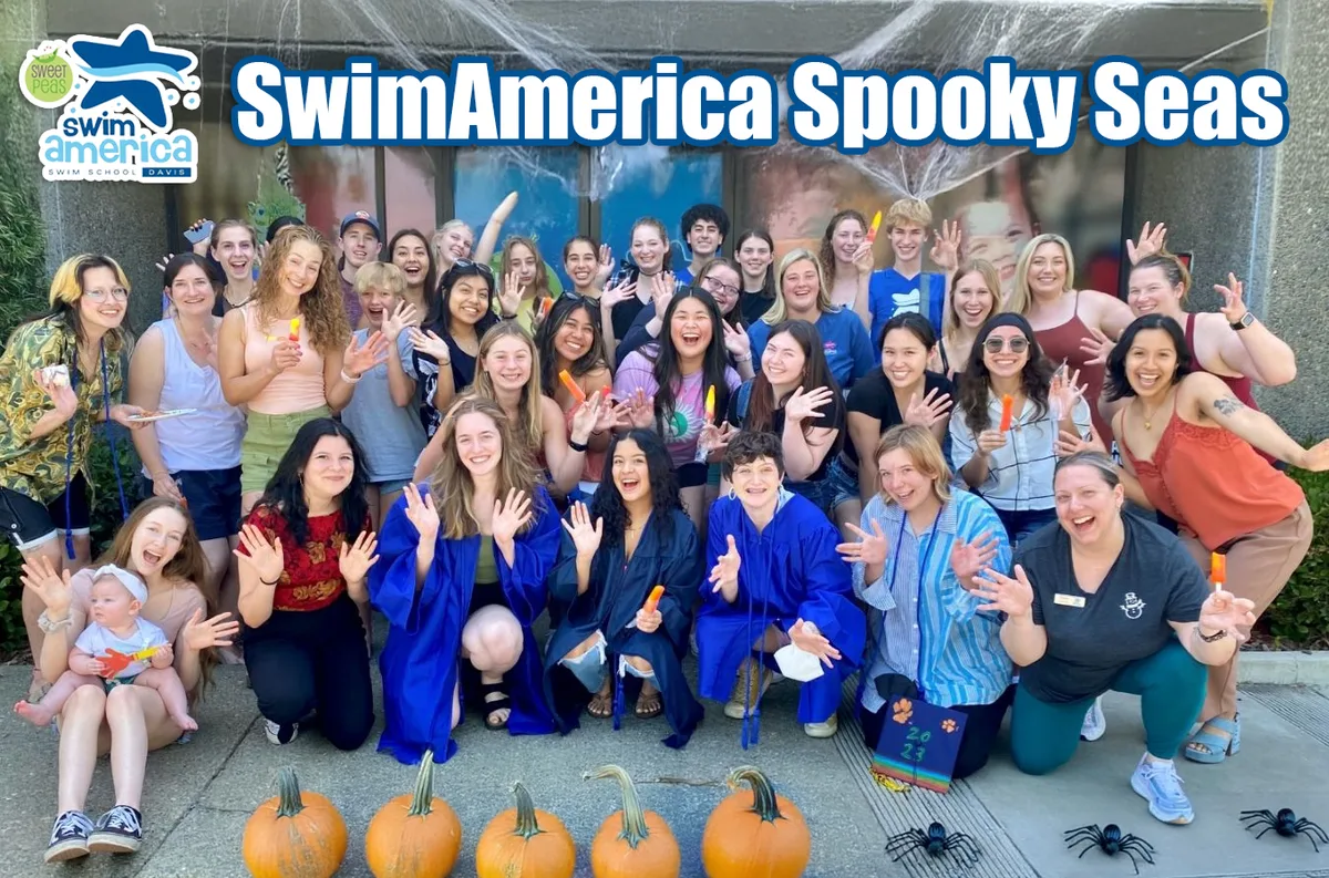 A large costumed group poses together at SwimAmerica's spooky swim event.