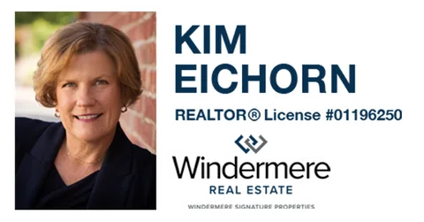 A real estate agent's headshot advertisement for Windermere Real Estate.