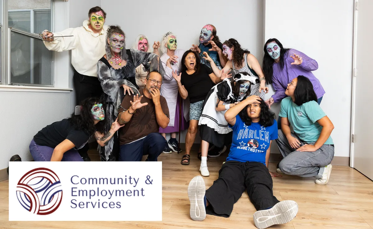 A costumed group poses playfully outside a community services office.
