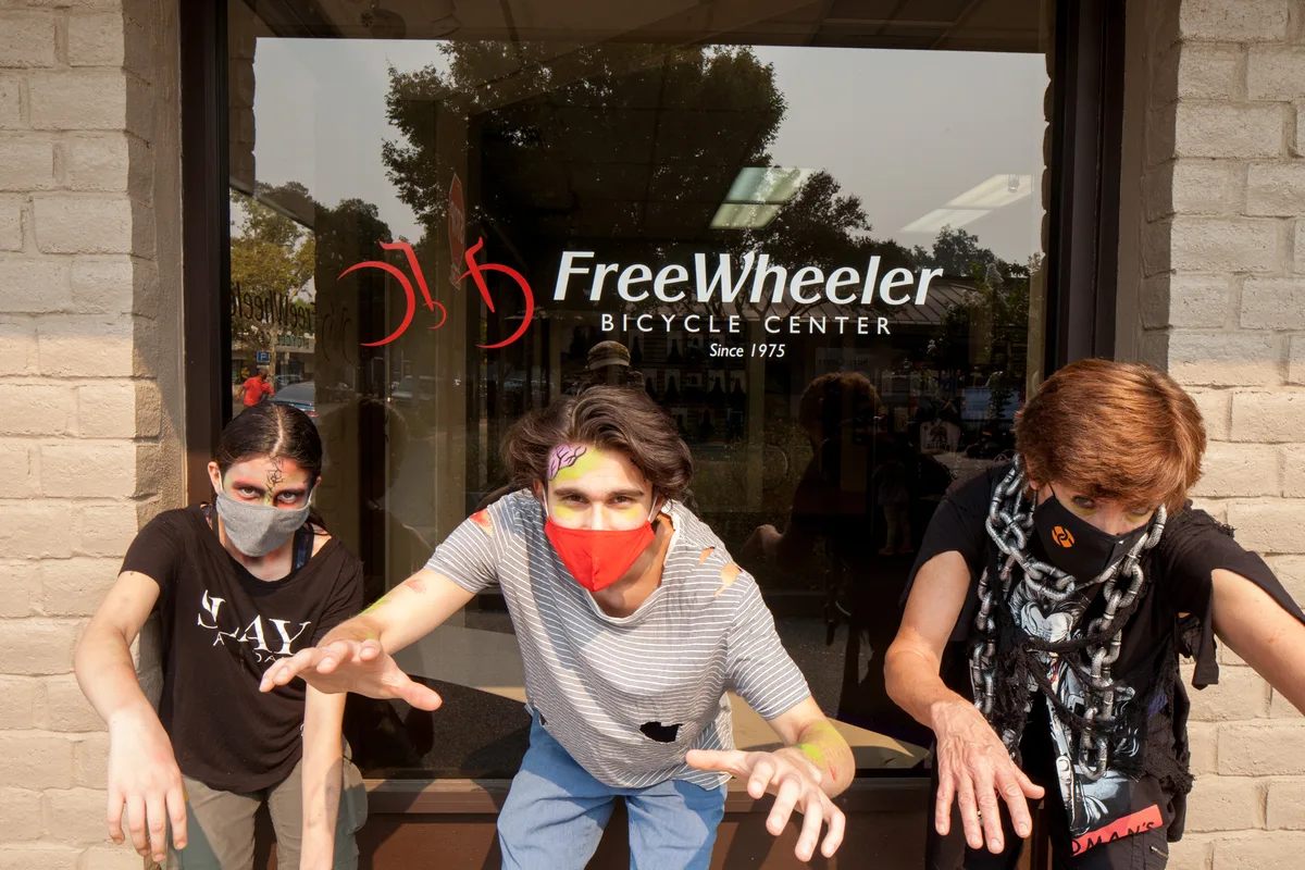 A man in a mask poses inside the FreeWheeler Bicycle Center shop.